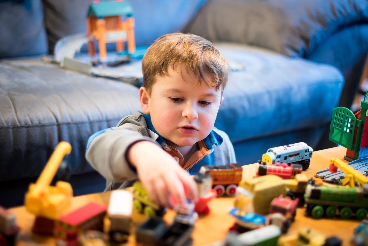 baby playing a game with own toys